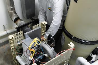 A pool technician performing repairs on a residential pool