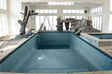 A pool technician performing a pool startup on a residential pool